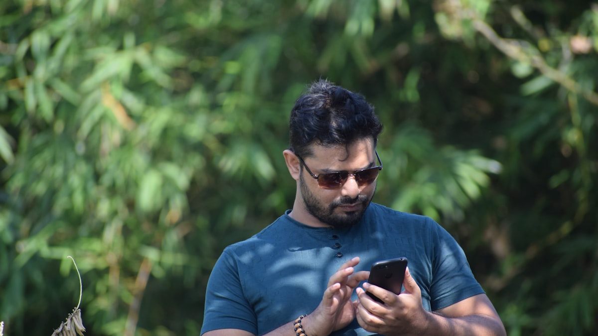 Indian small business owner checking smartphone for Aadhaar OTP during Udyam Registration